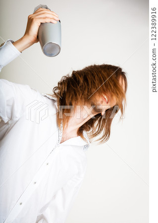 Long haired barman shaking head. 122389916