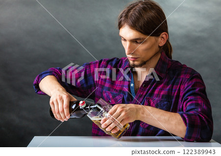 Tapster fills stein from bottle. Tapster fills stein from bottle. 122389943