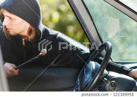 Thief burglar breaking into car Thief burglar breaking into car 122389958
