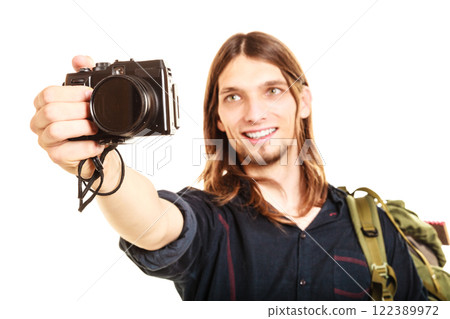 Man tourist backpacker taking photo with camera. Man tourist backpacker taking photo with camera. 122389972
