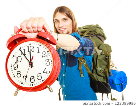 Travel time season. Man backpacker holding clock. 122389986