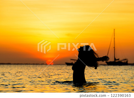Happy woman relaxes on beach 122390163
