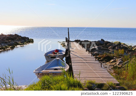 An old wooden pier with fishing boats 122390625