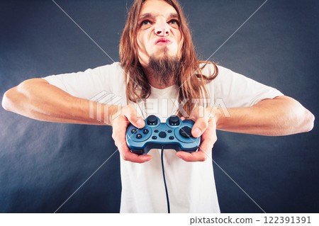 Stressed man playing on pad Stressed man playing on pad 122391391