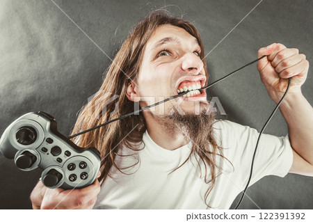Stressed man playing on pad 122391392