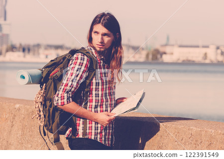 Man hiker with backpack tramping by seaside 122391549