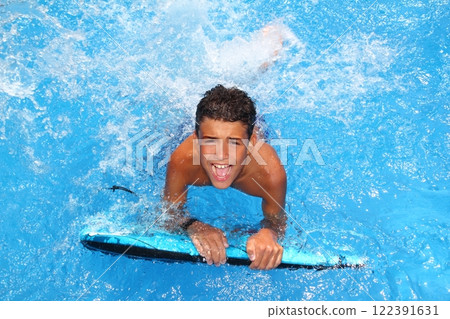 boy teenager surfboard splashing blue water 122391631