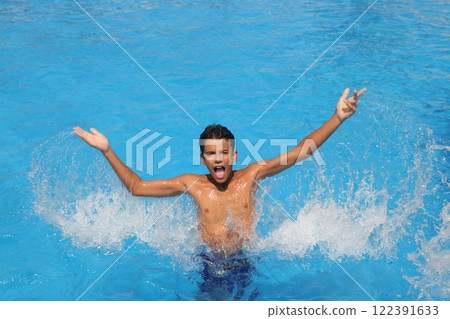 boy teenager splashing water open arms pool 122391633