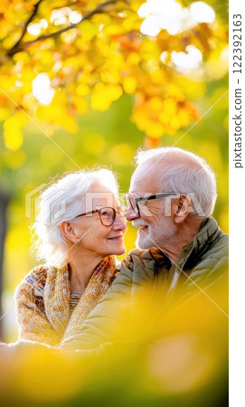 Couple enjoys peaceful moment on park bench under vibrant autumn foliage 122392163