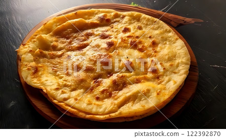 A flat, round roti, cooked perfectly, is ready to be enjoyed with food 122392870