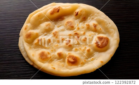 A flat, round roti, cooked perfectly, is ready to be enjoyed with food A flat, round roti, cooked perfectly, is ready to be enjoyed with food 122392872