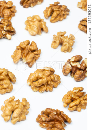 Shelled walnuts on a white background close-up Shelled walnuts on a white background close-up 122393081