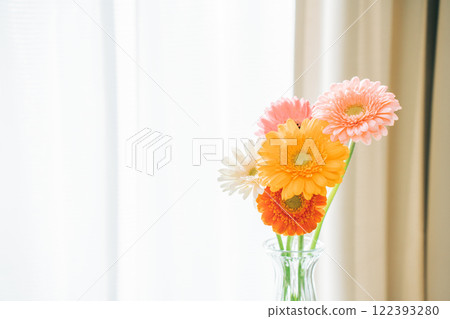 A vase of gerberas on a windowsill 122393280