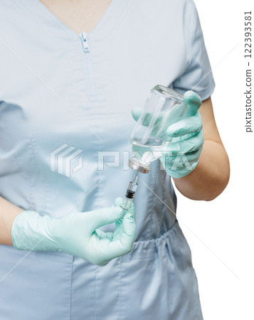 Female physician in latex gloves holding syringe and picking up liquid medicine for injection. 122393581