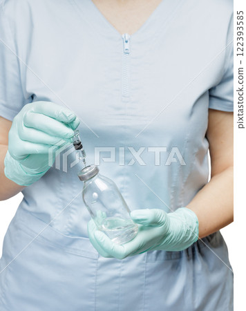 Plastic syringe and bottle for liquid medicine in hands. 122393585