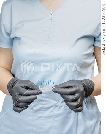 Dentist in gloves with interdental toothpick brushes. 122393598