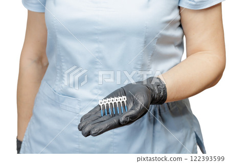 Dentist in gloves with interdental toothpick brushes. 122393599