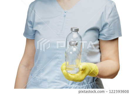 Female physician in latex gloves holding bottles for liquid medicine. 122393608