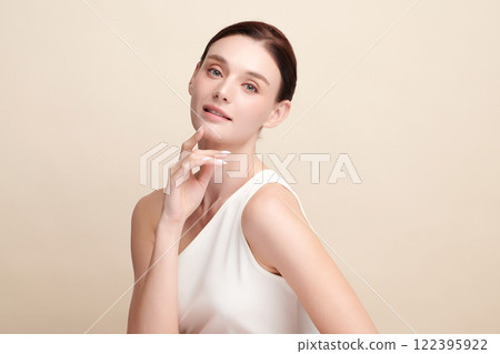 Beautiful young woman with clean fresh skin on beige background, Face care, Facial treatment, Cosmetology, beauty and spa, women portrait. 122395922