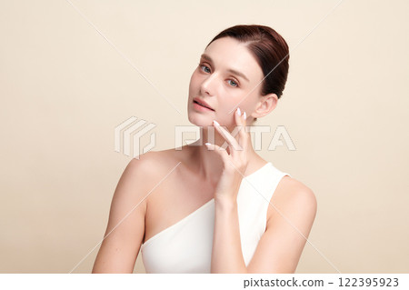 Beautiful young woman with clean fresh skin on beige background, Face care, Facial treatment, Cosmetology, beauty and spa, women portrait. Beautiful young woman with clean fresh skin on beige background, Face care, Facial treatment, Cosmetology, beauty and spa, women portrait. 122395923