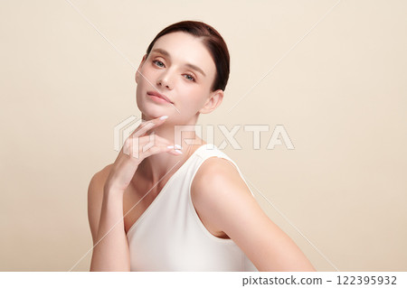 Beautiful young woman with clean fresh skin on beige background, Face care, Facial treatment, Cosmetology, beauty and spa, women portrait. Beautiful young woman with clean fresh skin on beige background, Face care, Facial treatment, Cosmetology, beauty and spa, women portrait. 122395932