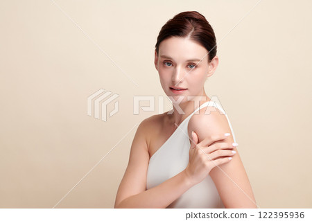 Beautiful young woman with clean fresh skin on beige background, Face care, Facial treatment, Cosmetology, beauty and spa, women portrait. Beautiful young woman with clean fresh skin on beige background, Face care, Facial treatment, Cosmetology, beauty and spa, women portrait. 122395936