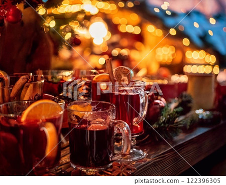Enjoying warm mulled wine at a festive Christmas market in December evening 122396305