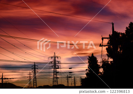A typical Japanese town skyline with a tangle of steel towers and power lines 122396813