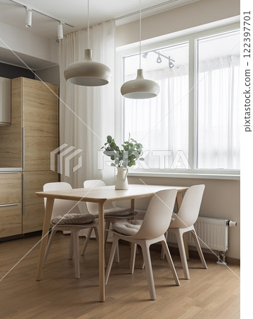 A modern minimalist dining space that invites natural light and showcases beautiful greenery A modern minimalist dining space that invites natural light and showcases beautiful greenery 122397701