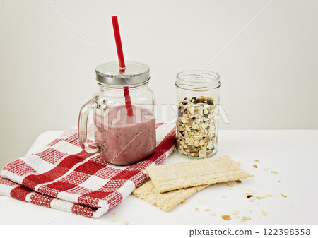 Strawberry smoothie with granola and crackerbreads for healthy breakfast. Healthy life style concept 122398358