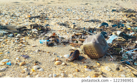 Garbage, plastic, and wastes on the beach of Portugal. Sand beaches polluted with pieces of plastic, cigarette pack Garbage, plastic, and wastes on the beach of Portugal. Sand beaches polluted with pieces of plastic, cigarette pack 122398901