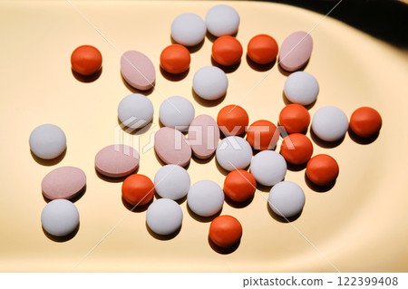 Colorful pills on a golden background. 122399408