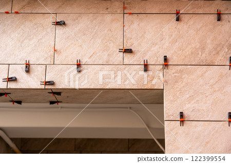 Tile leveling system with plastic clips and wedges, shot while the tile mortar sets. Tile leveling system with plastic clips and wedges, shot while the tile mortar sets. 122399554