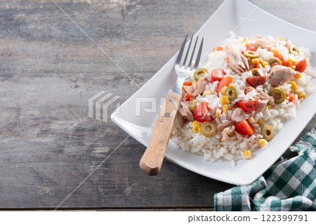 Rice salad with tomato, corn,olives and tuna on wooden table Rice salad with tomato, corn,olives and tuna on wooden table 122399791