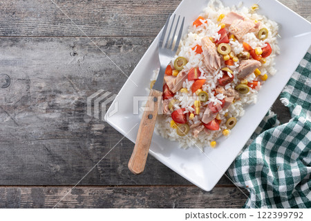Rice salad with tomato, corn,olives and tuna on wooden table 122399792