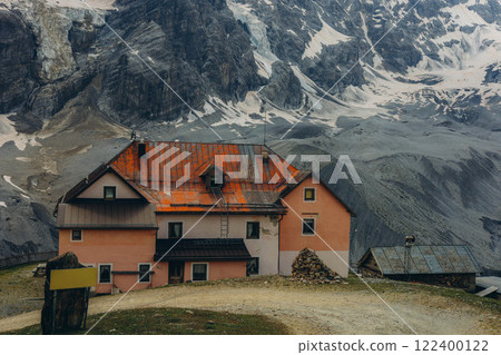 Charming mountain hut, nestled amidst the rugged peaks and lush greenery of the Alps 122400122