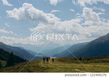 Group of hikers with trekking poles and backpacks,hiking in the Italian Alps 122400170