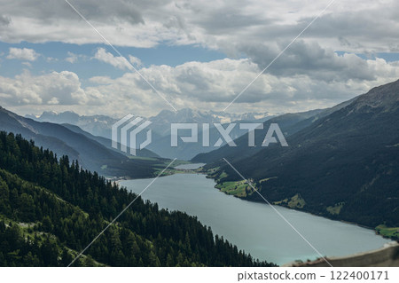 Panoramic view of the Italian Alps with a mountain lake, showcasing stunning natural beauty. 122400171