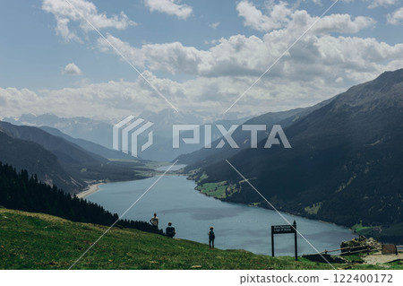 Panoramic view of the Italian Alps with a mountain lake, showcasing stunning natural beauty. 122400172