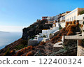 Picturesque view of the ancient Thira, Santorini. Traditional white houses and terraces against blue sky and sea. 122400324
