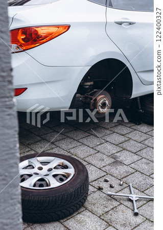Emergency situation with a car, replacing a tire on the roadside Emergency situation with a car, replacing a tire on the roadside 122400327