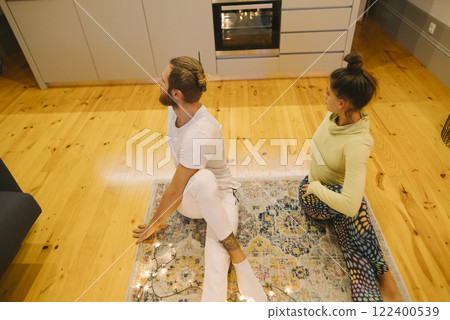 A Beautiful Couple Practicing Yoga Together in a Cozy and Inviting Space at Home A Beautiful Couple Practicing Yoga Together in a Cozy and Inviting Space at Home 122400539