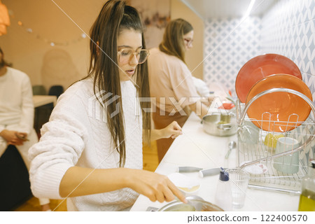 Cooking Together Embracing Culinary Creativity in a Cozy and Inviting Kitchen Setting Cooking Together Embracing Culinary Creativity in a Cozy and Inviting Kitchen Setting 122400570