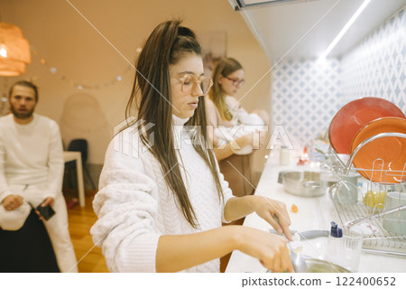 A Cozy Home Gathering Filled with Cooking, Family Moments, and Shared Joy Togetherness 122400652