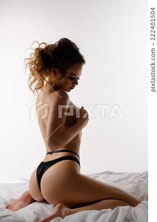 Couple expressing intimacy in alluring lingerie during a romantic moment Couple expressing intimacy in alluring lingerie during a romantic moment 122401504