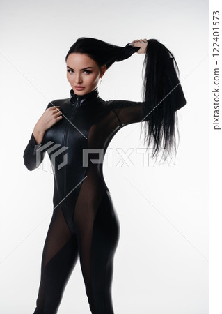 Striking beauty poses in stylish lingerie with dramatic lighting in studio 122401573