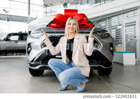 Business woman receiving new car as a gift in dealership Business woman receiving new car as a gift in dealership 122401631