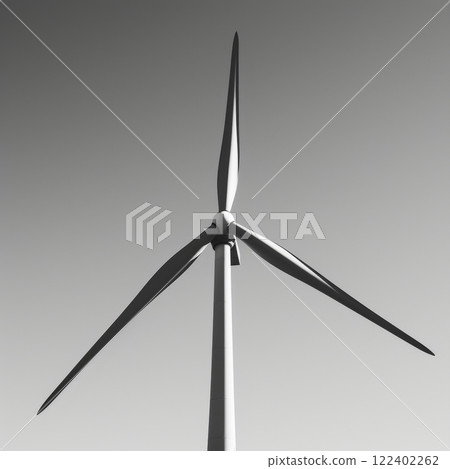 The sharp angles of the windmill bladesart.e accentuated in its silhouette against a cleart.blue sky. Black and white art. 122402262