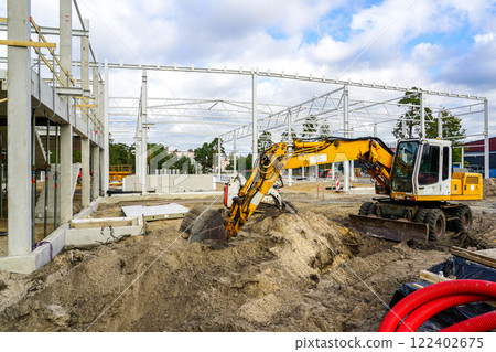 Construction site of a new modern factory reinforced concrete and metal structure building frame 122402675