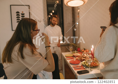 Dinner Gathering with Friends in a Cozy and Inviting Atmosphere for Good Times and Fun 122402851
